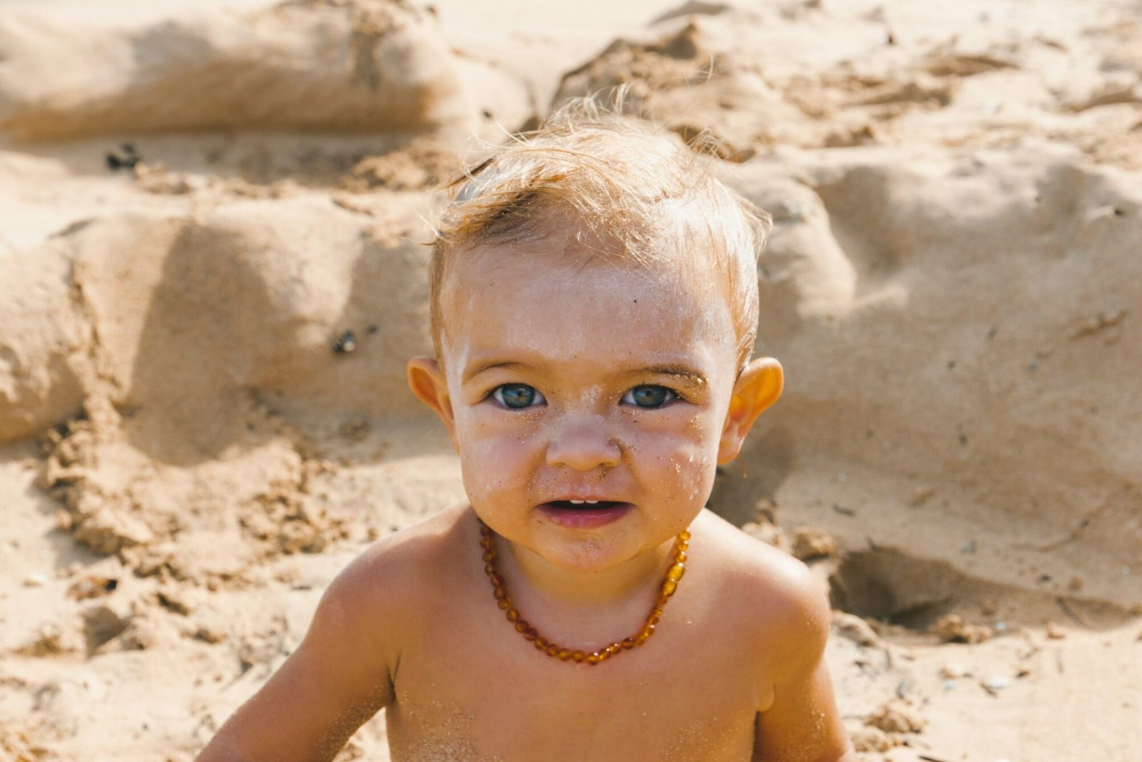 a little boy that is standing in the sand