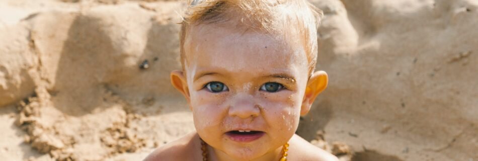 a little boy that is standing in the sand